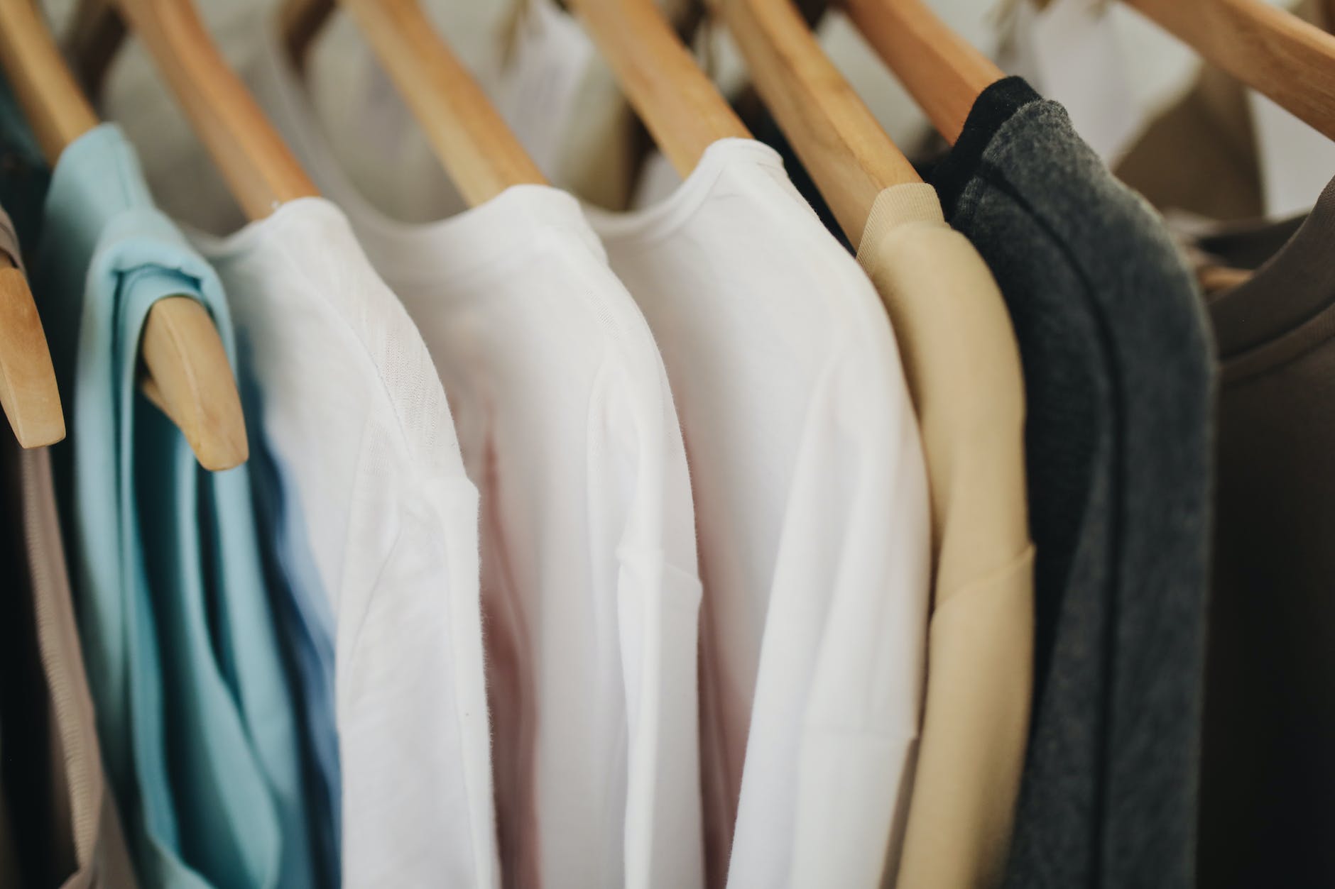 white long sleeves shirts on brown wooden clothes hanger